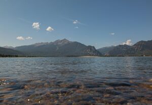 a clear lake with mountains in the background in Frisco, CO